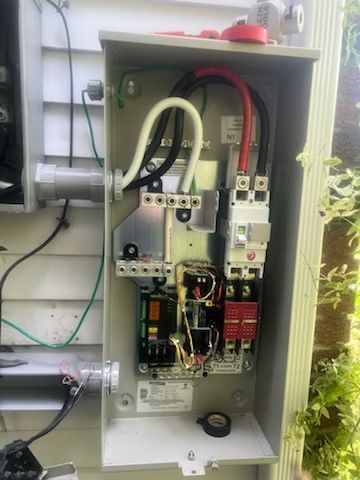 A electrical box with a lot of wires coming out of it.