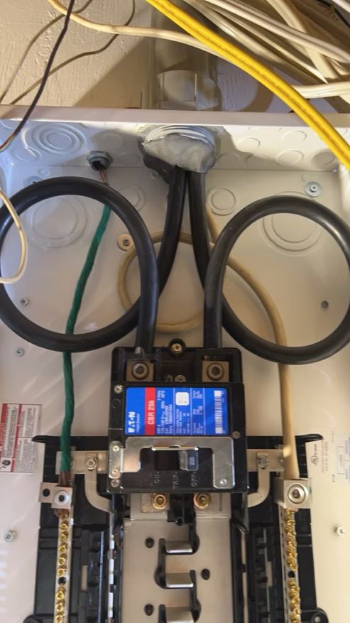 A close up of an electrical box with wires coming out of it.