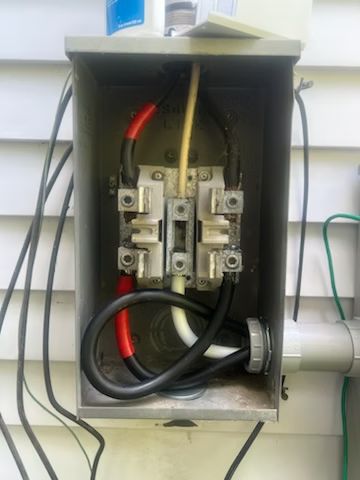 An electrical box with a lot of wires coming out of it