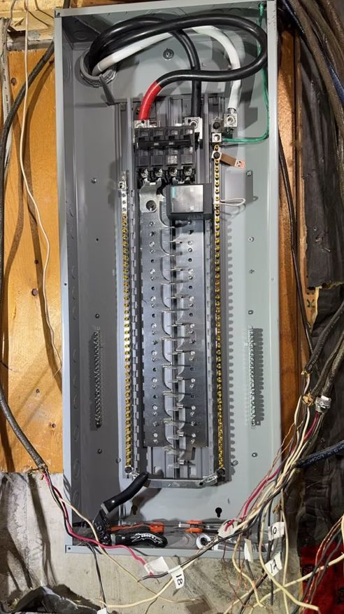 A close up of an electrical box with wires coming out of it.