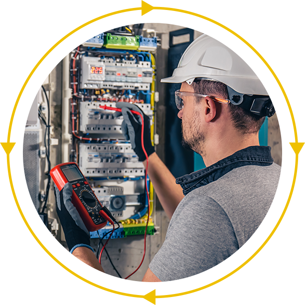 A man in a hard hat is working on an electrical box.