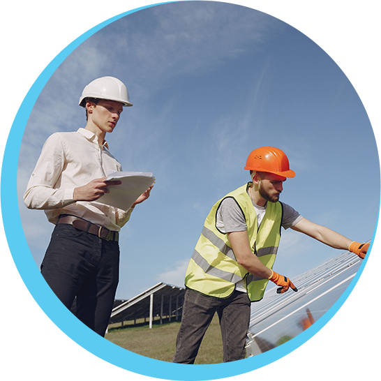 Two men wearing hard hats are working on a solar panel