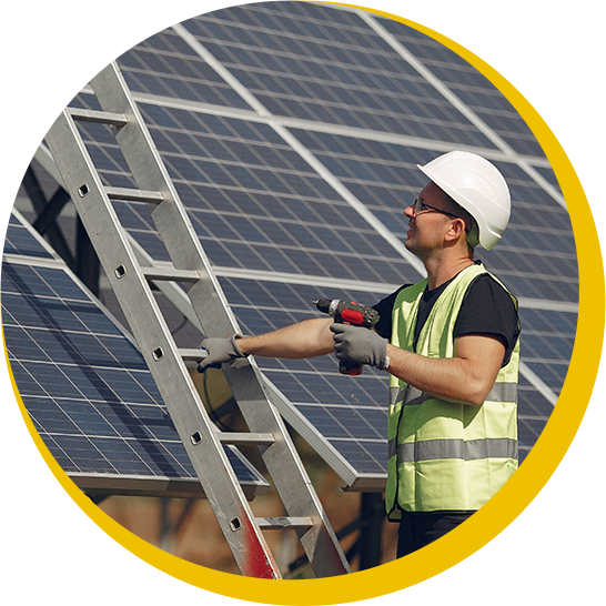 A man on a ladder working on solar panels