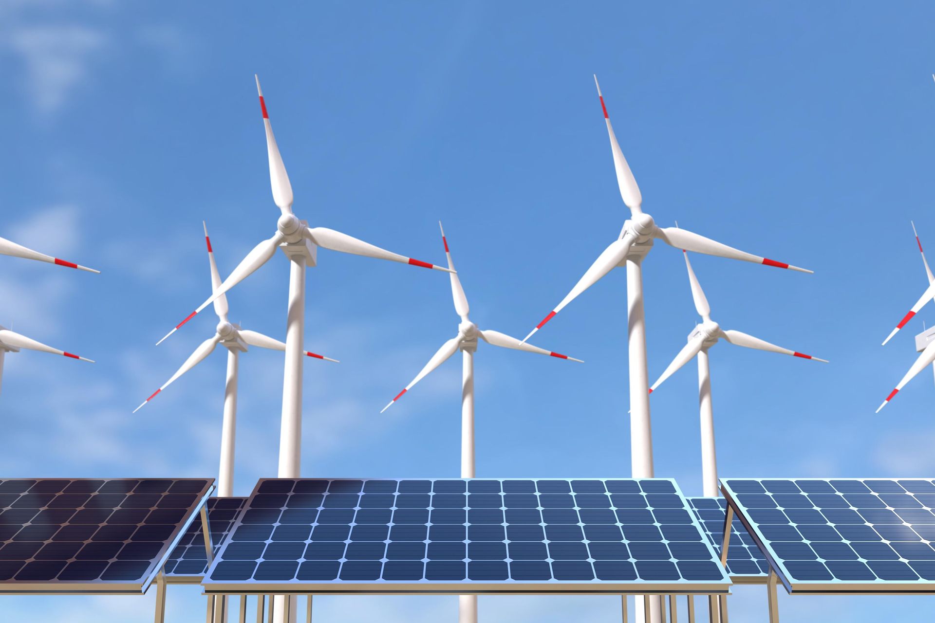 A row of wind turbines and solar panels against a blue sky