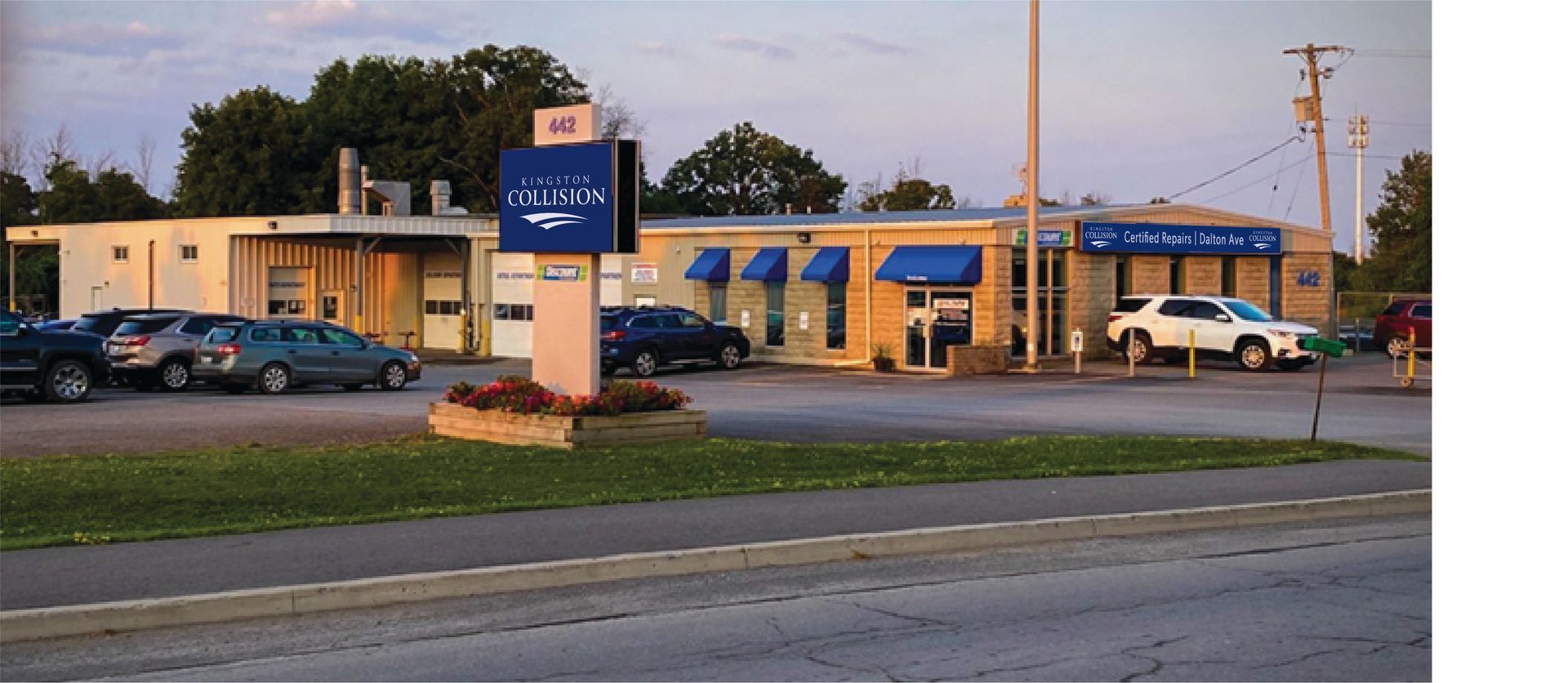 A parking lot with cars parked in front of a pharmacy
