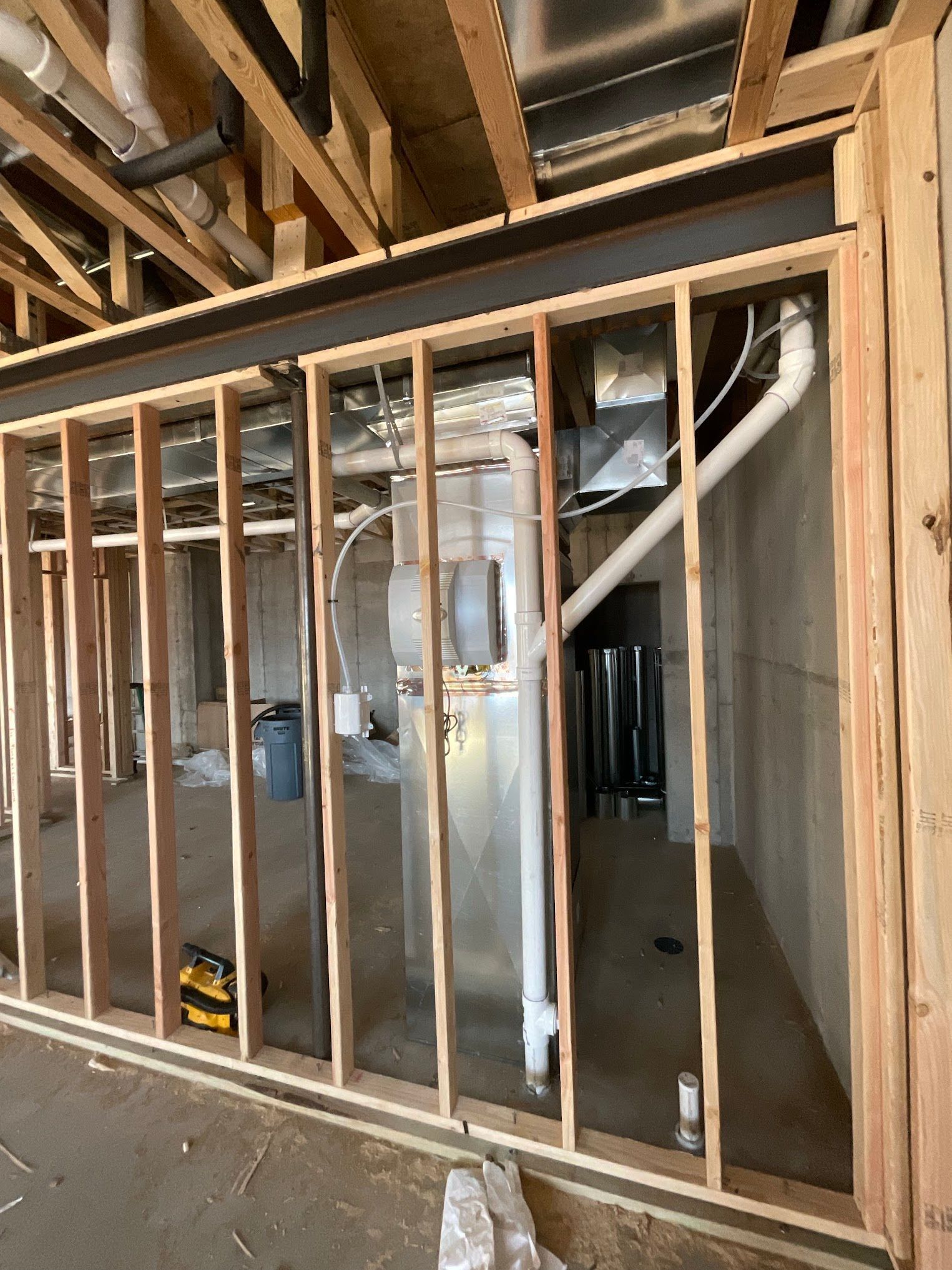 A room with a lot of pipes coming out of it is being built.