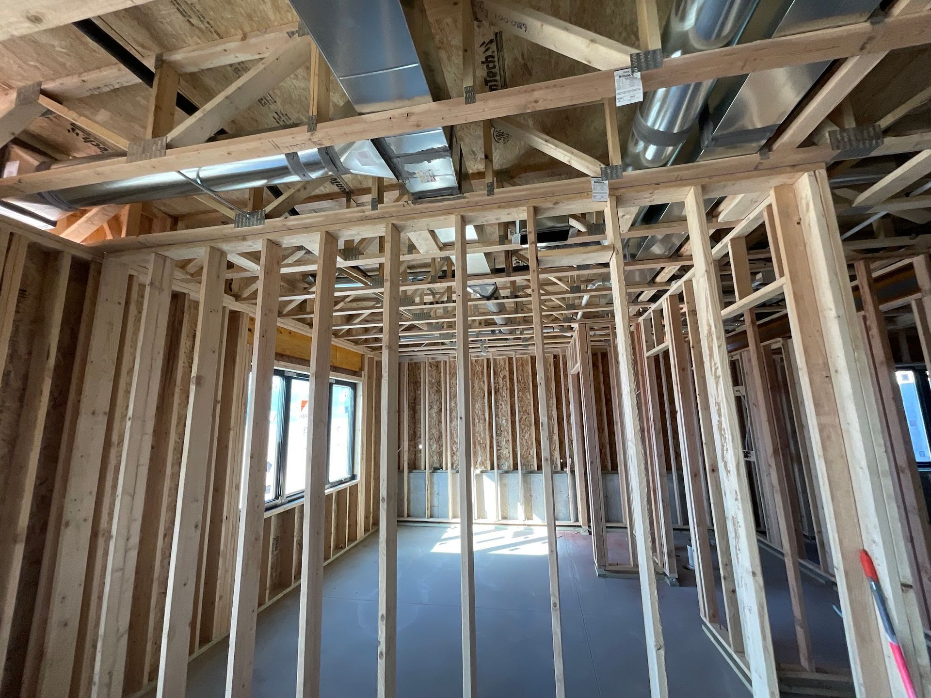 The inside of a building under construction with a lot of wooden beams.