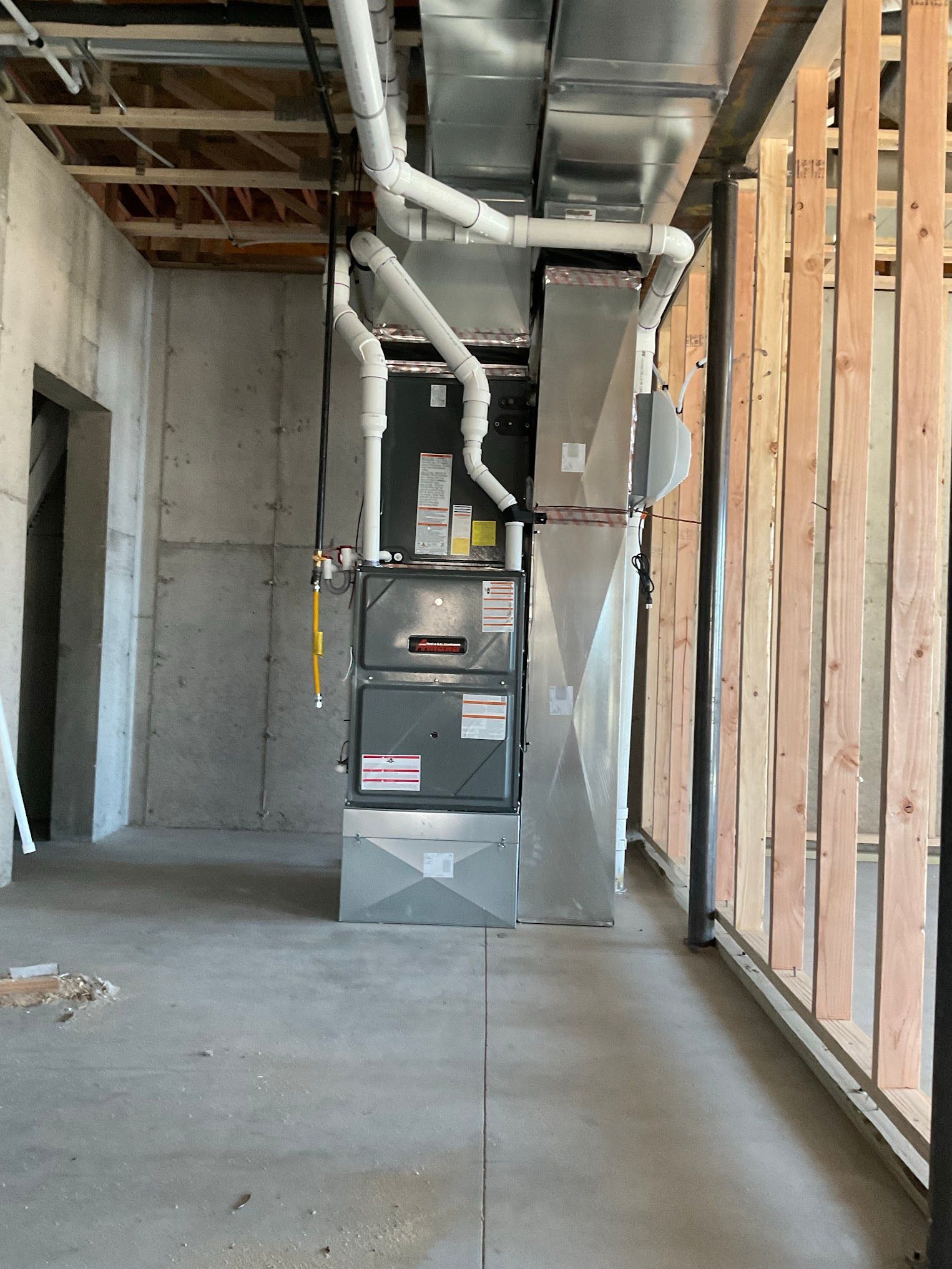 A room with a lot of pipes hanging from the ceiling.