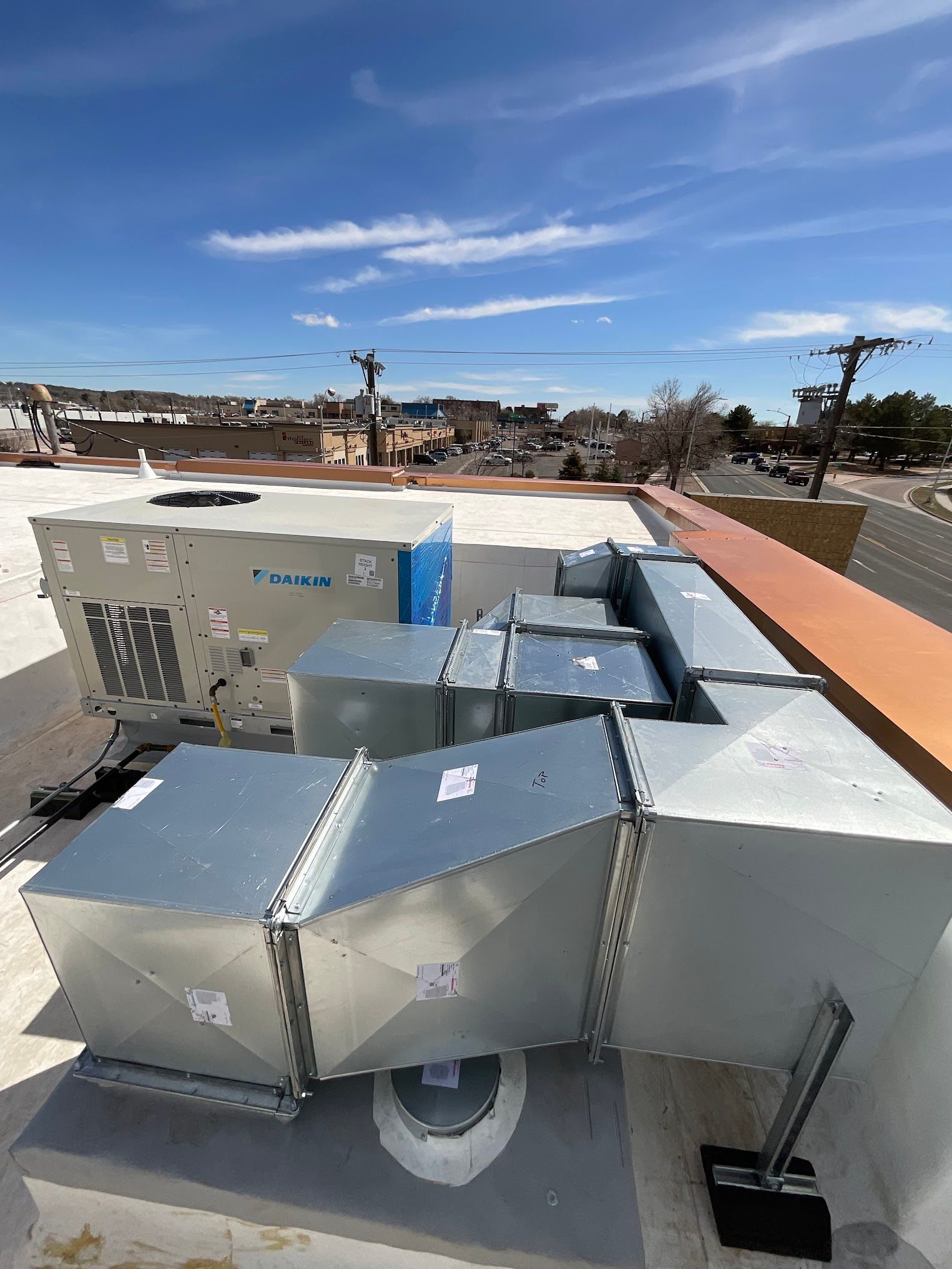 The roof of a building with a lot of ductwork on it.