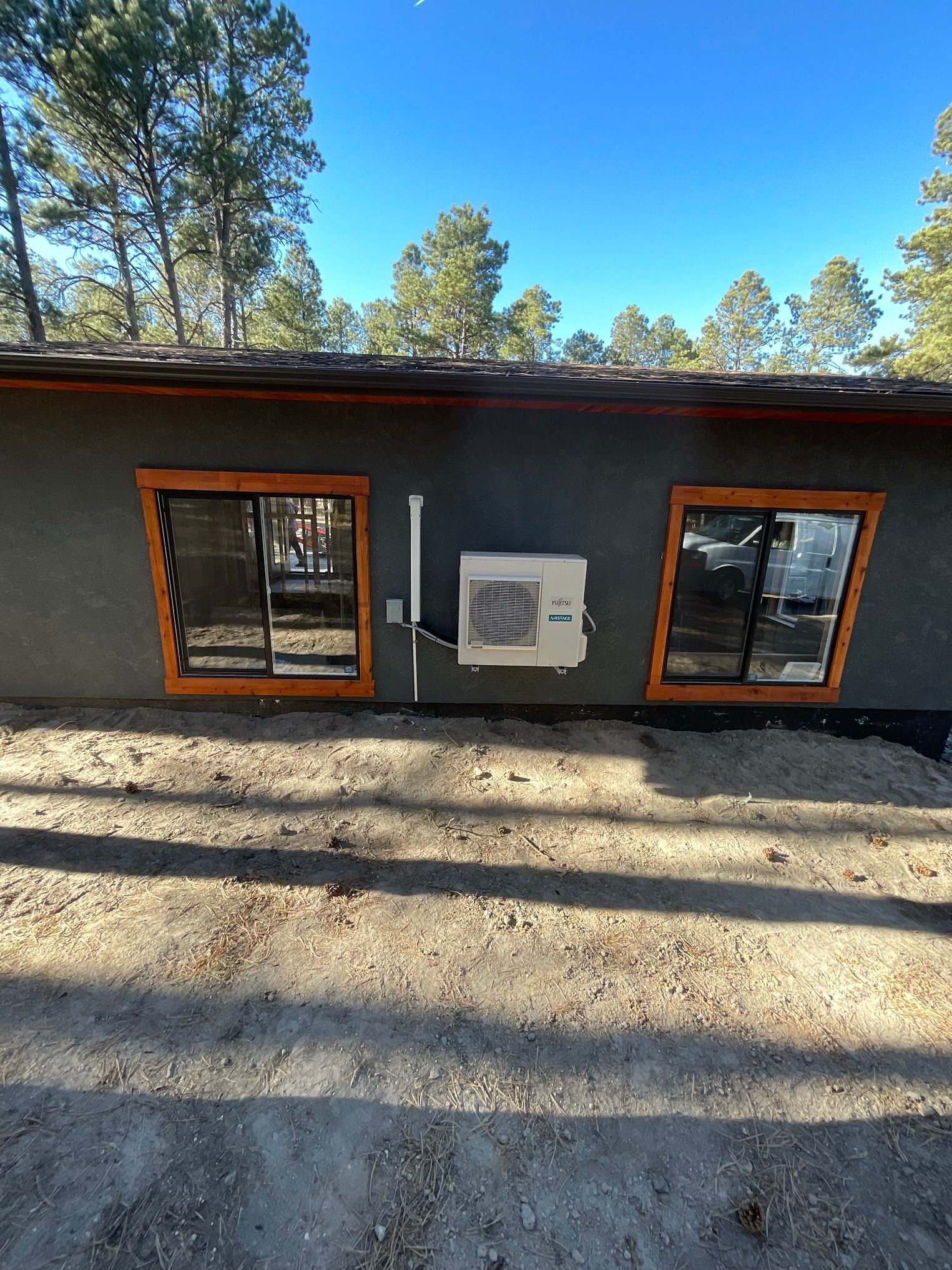A house with a lot of windows and a fan on the side of it.