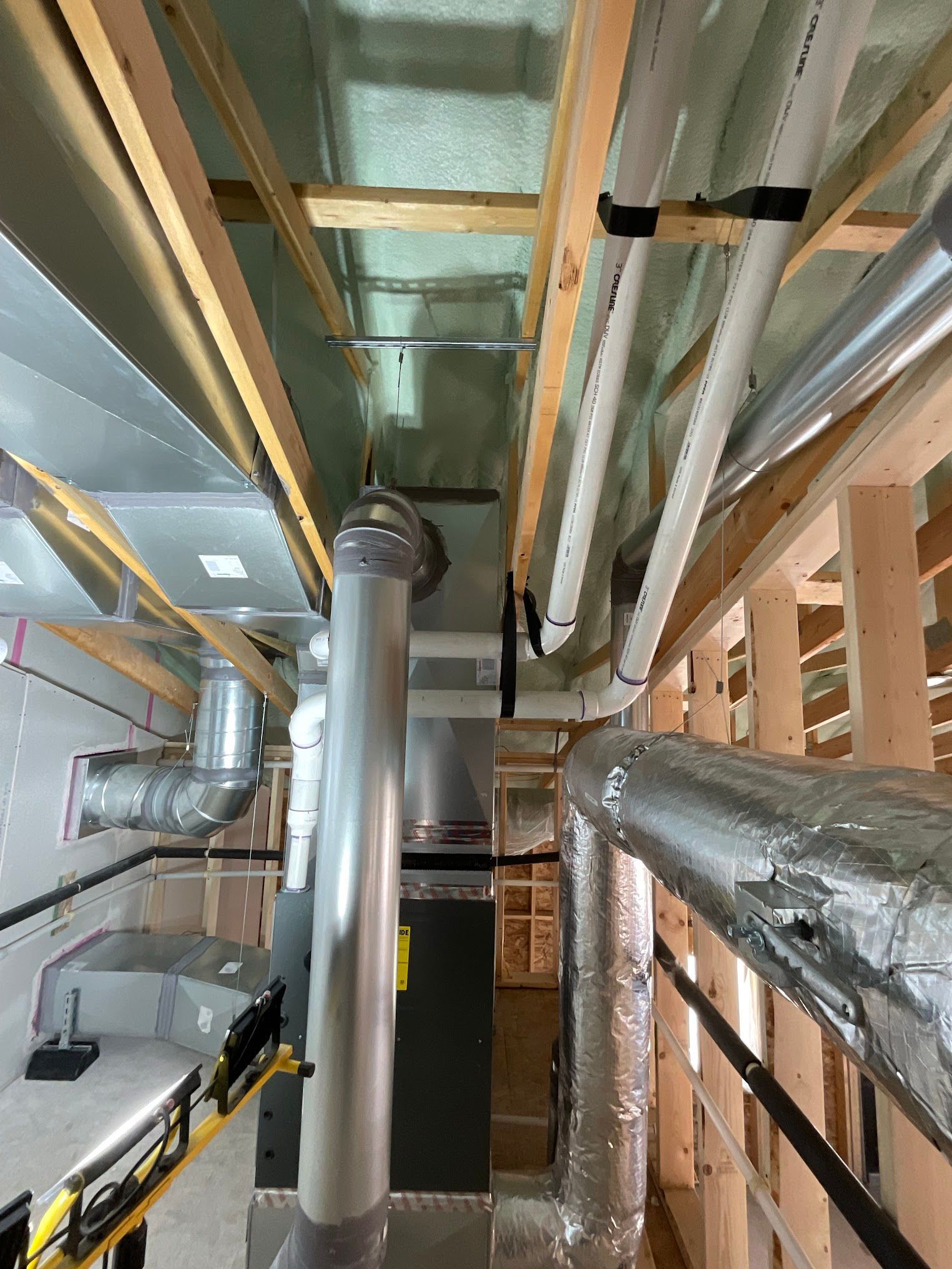 A room with a lot of pipes coming out of the ceiling.