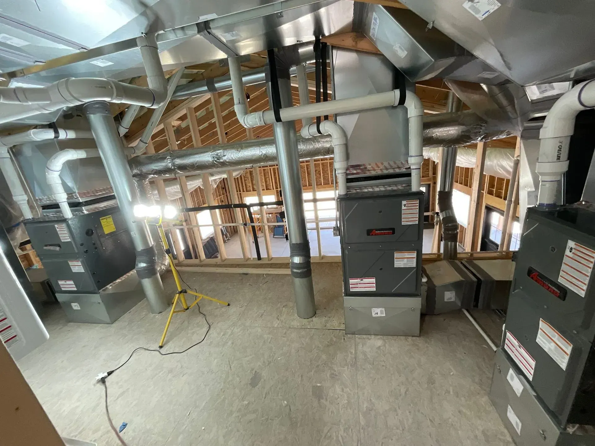 A room with a lot of pipes hanging from the ceiling.