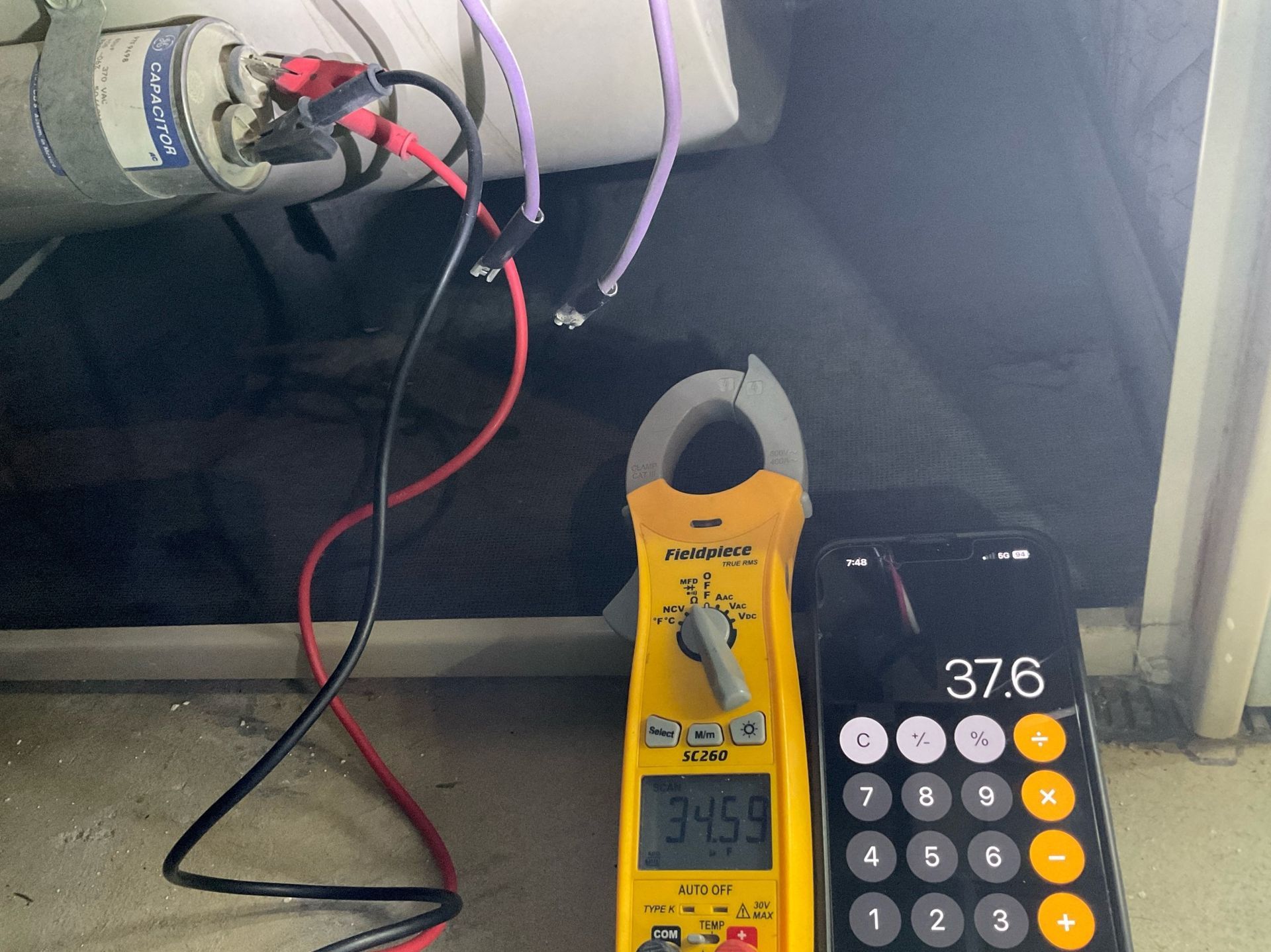 A calculator and a clamp meter are next to each other