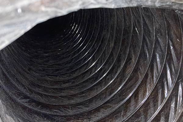 A close up of a black duct with a spiral pattern.
