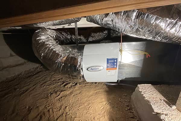A picture of a ventilation system in a basement.