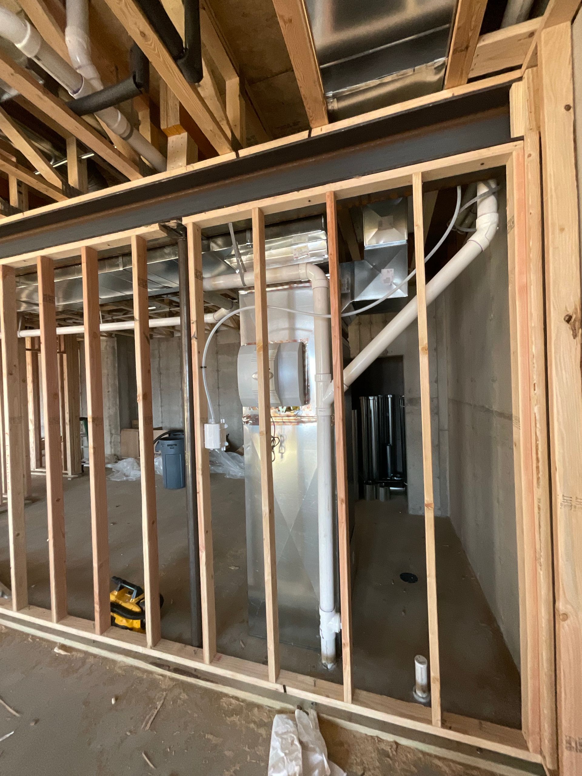 A room with a lot of wooden frames and pipes in it