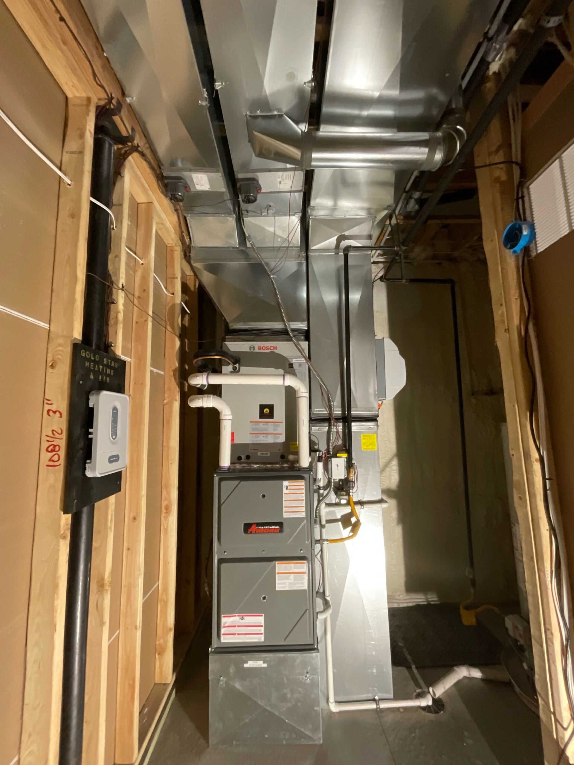 A picture of a gas furnace in a basement.