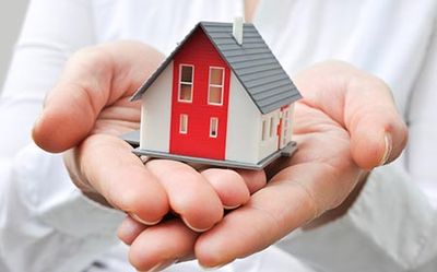 Home Insurance — Hands Holding a House Toy in Ontario, OH