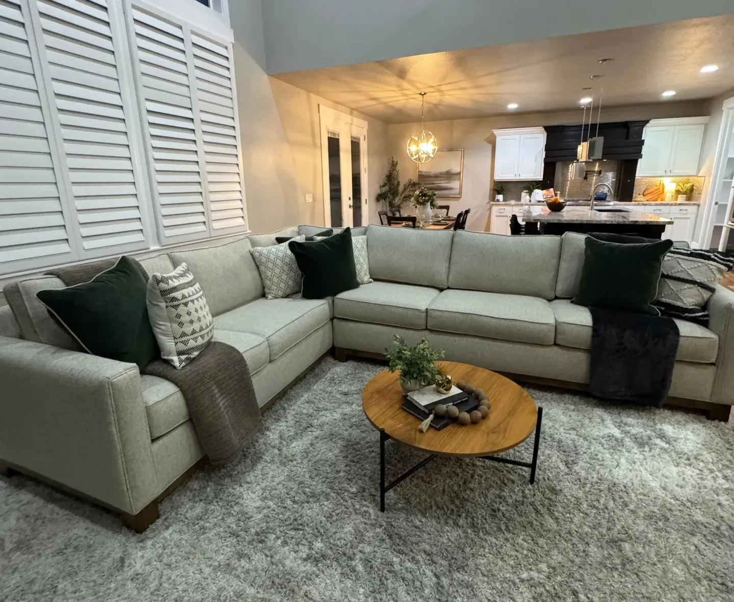 Living room with sectional sofa, coffee table, and area rug. Living room with sectional sofa, coffee table, and area rug.