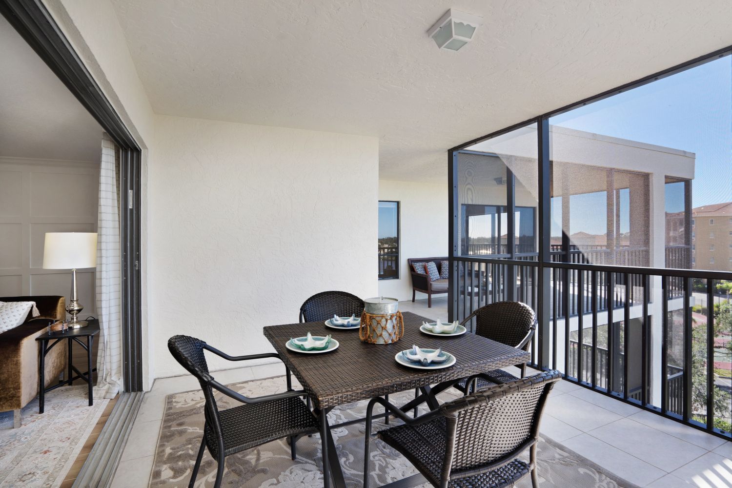 There is a table and chairs on the balcony.