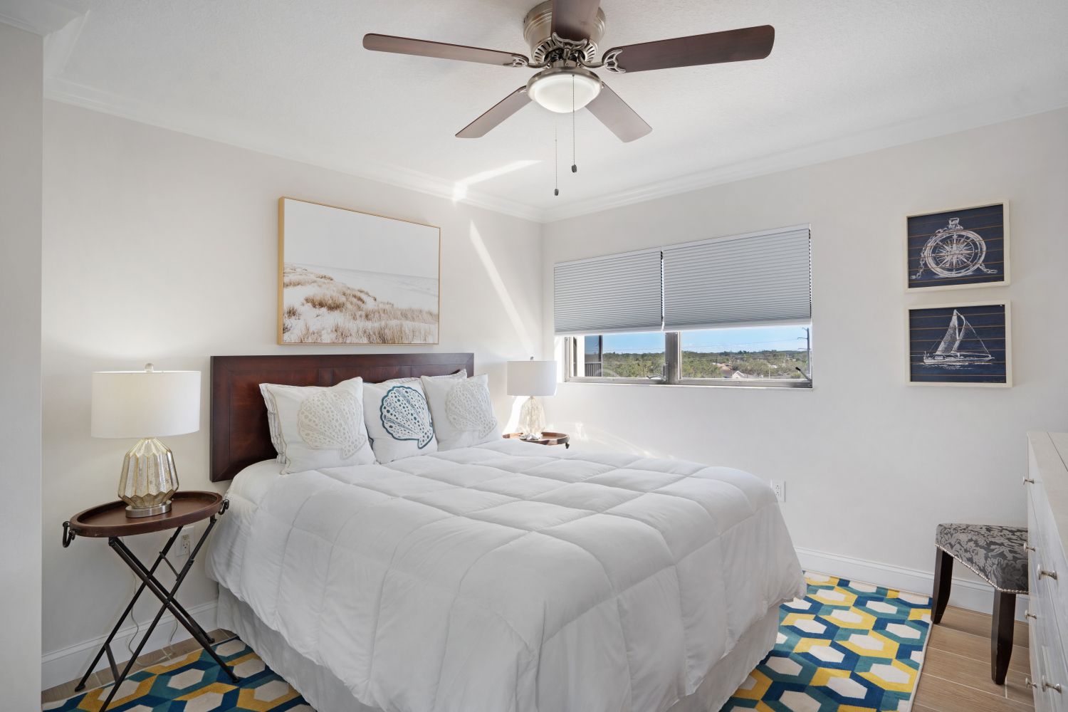 A bedroom with a bed and a ceiling fan.