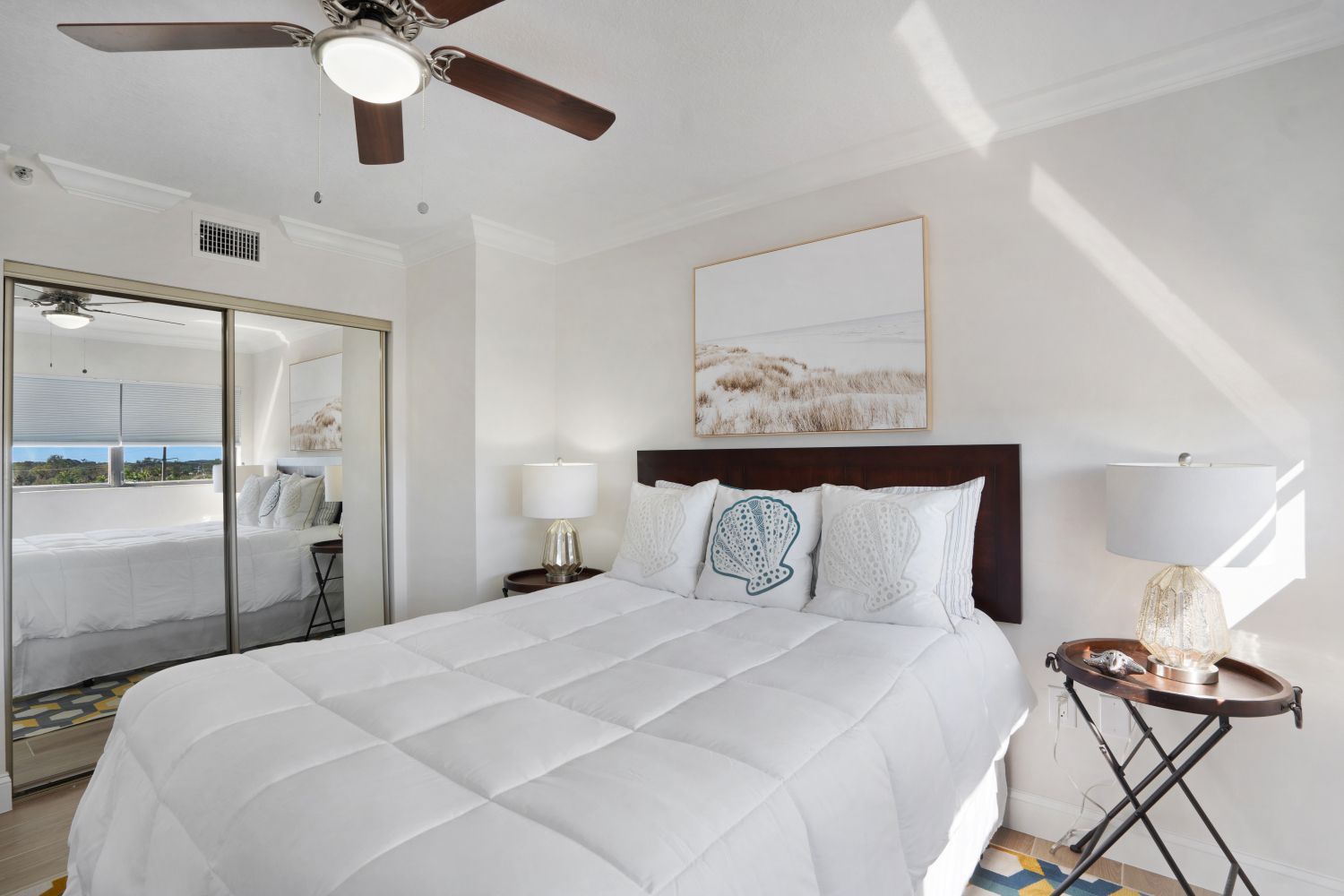 A bedroom with a bed and a ceiling fan