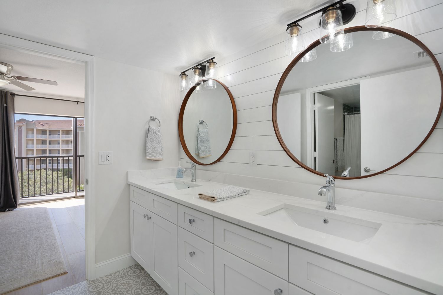 A bathroom with two sinks and two mirrors.