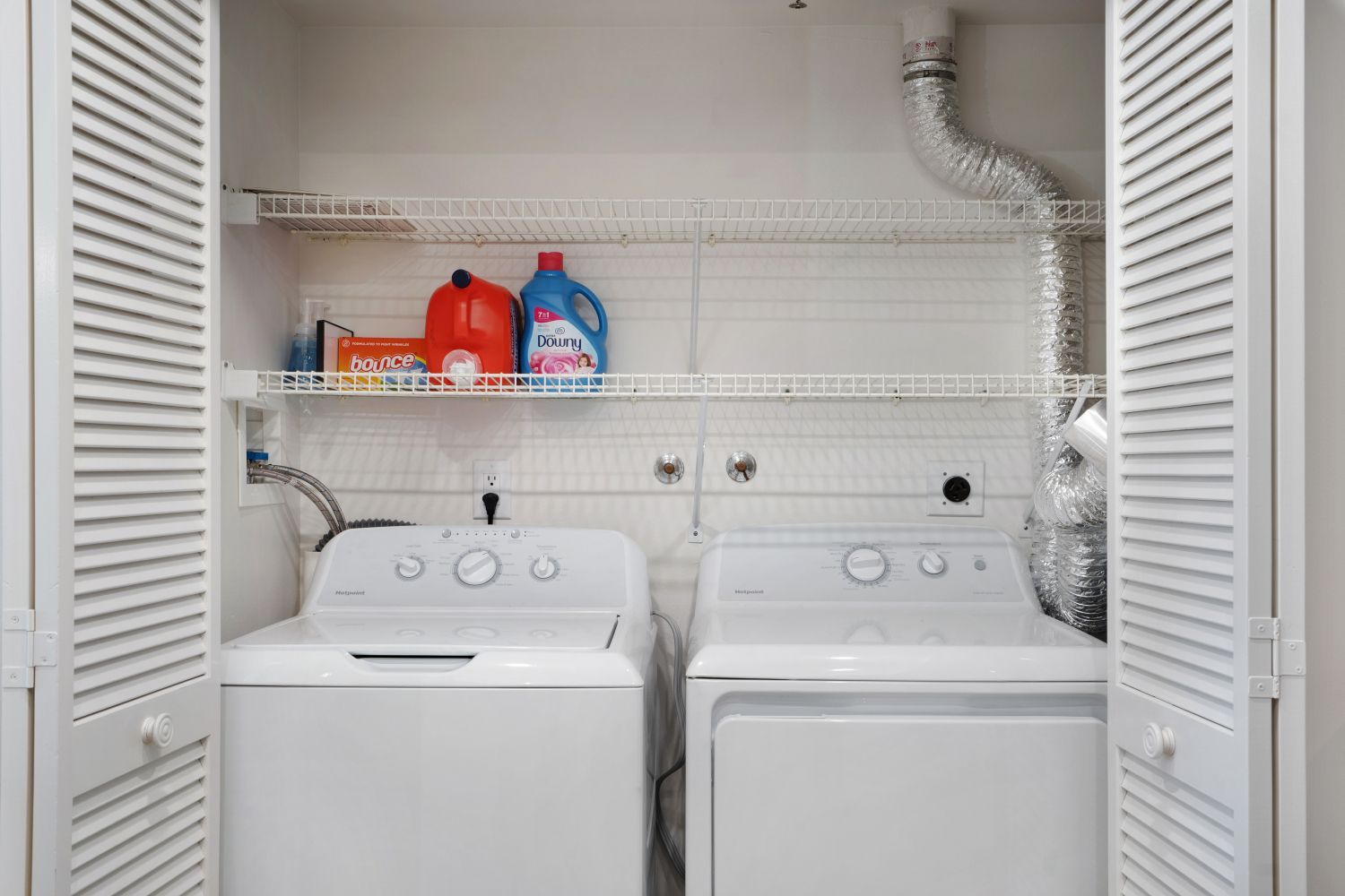 A laundry room with a washer and dryer in a closet.