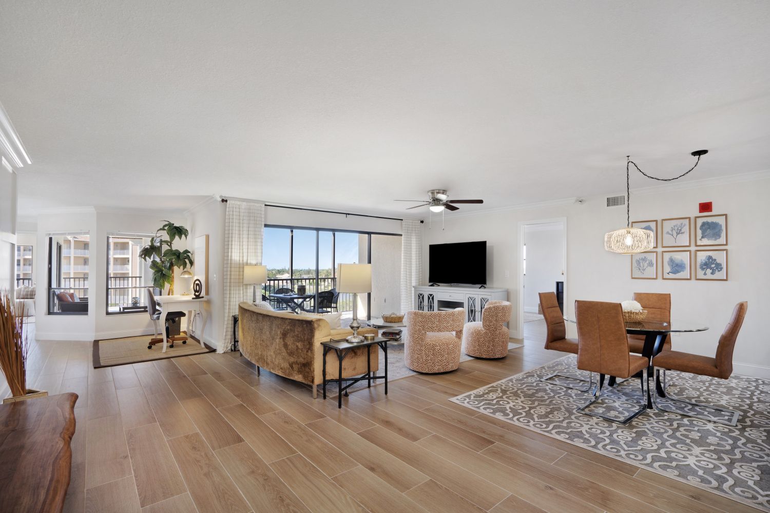 A living room with hardwood floors and a dining room with a table and chairs.