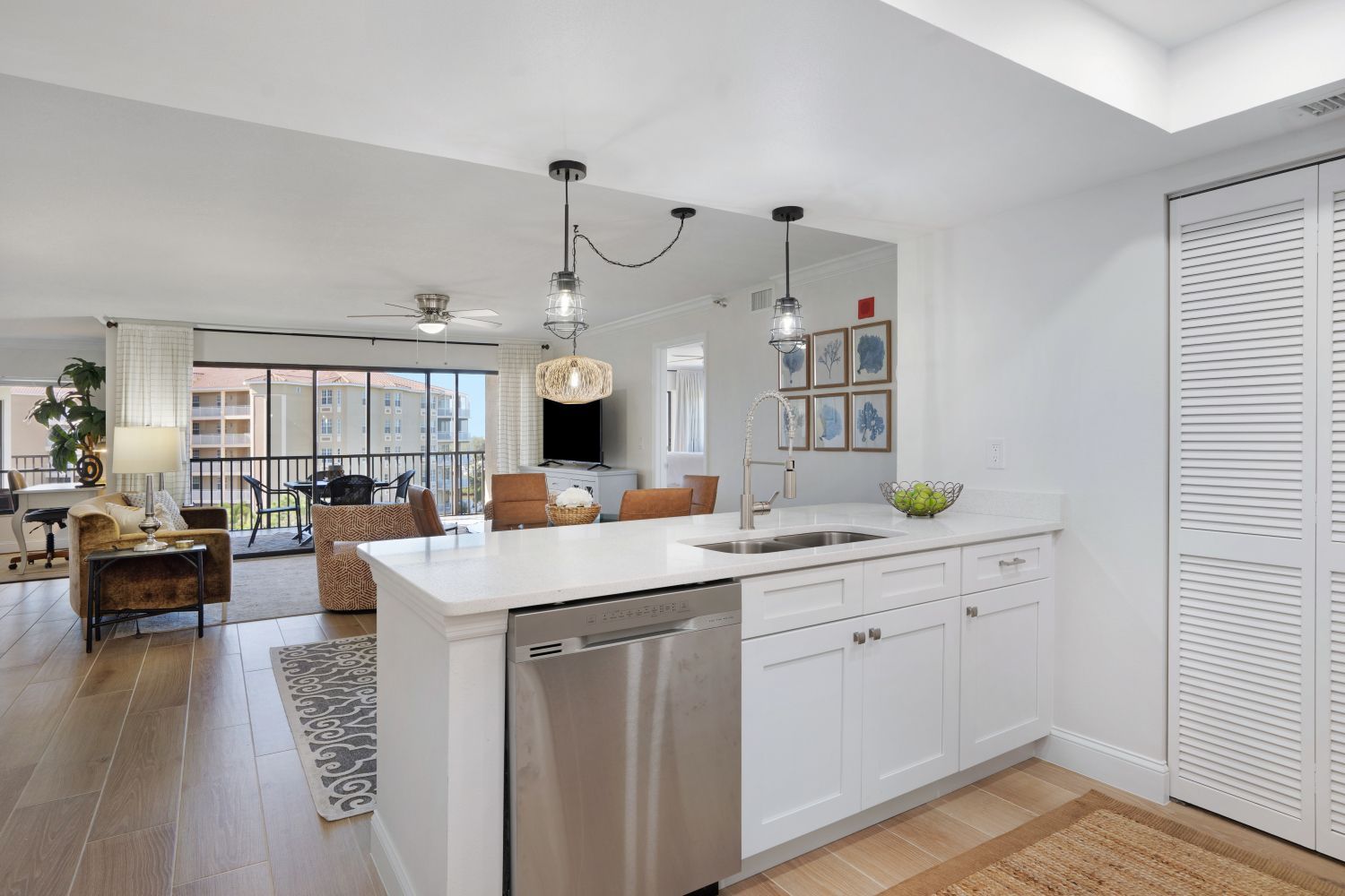 A kitchen with white cabinets and a stainless steel dishwasher.