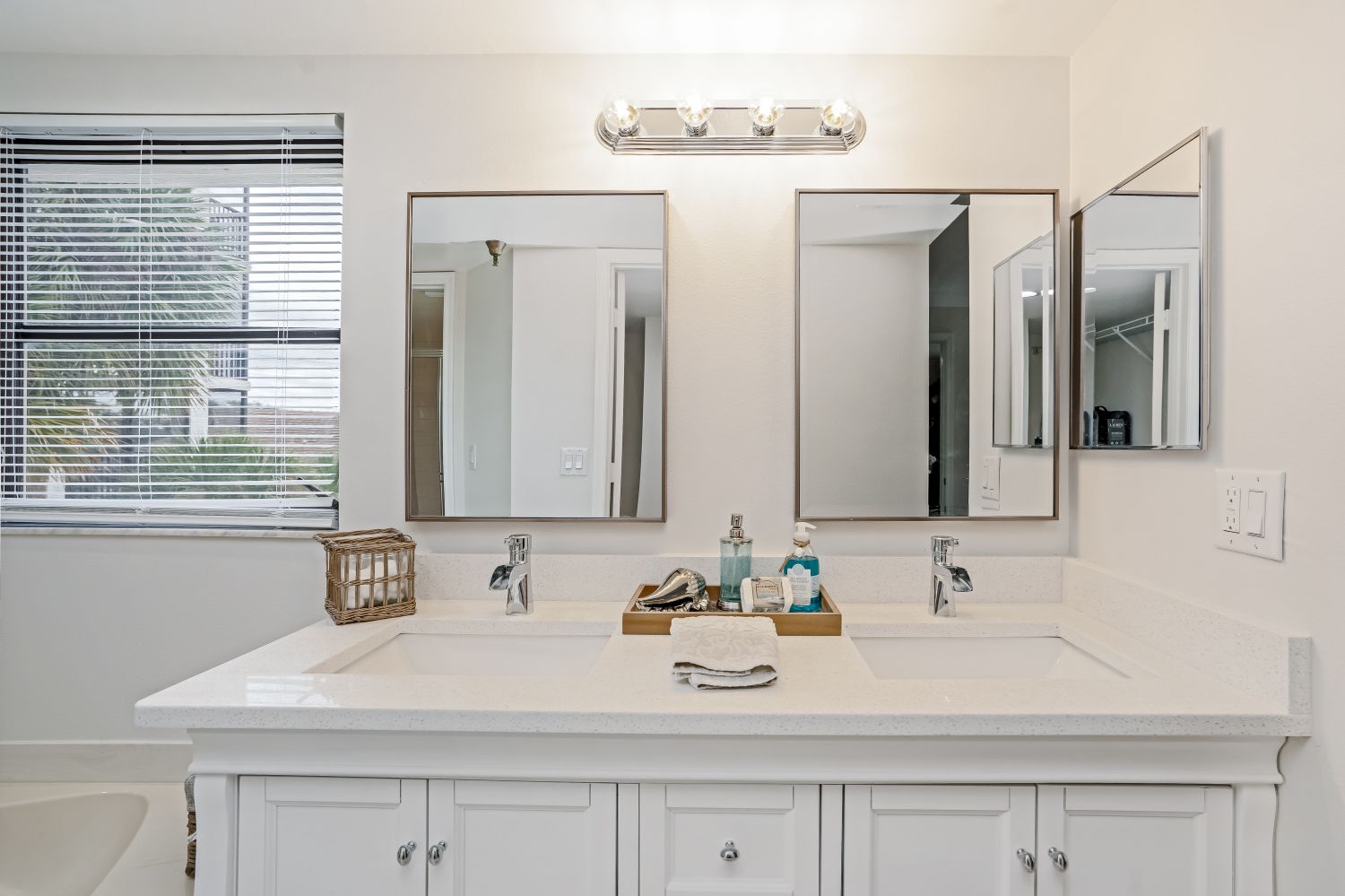 A bathroom with two sinks and two mirrors.