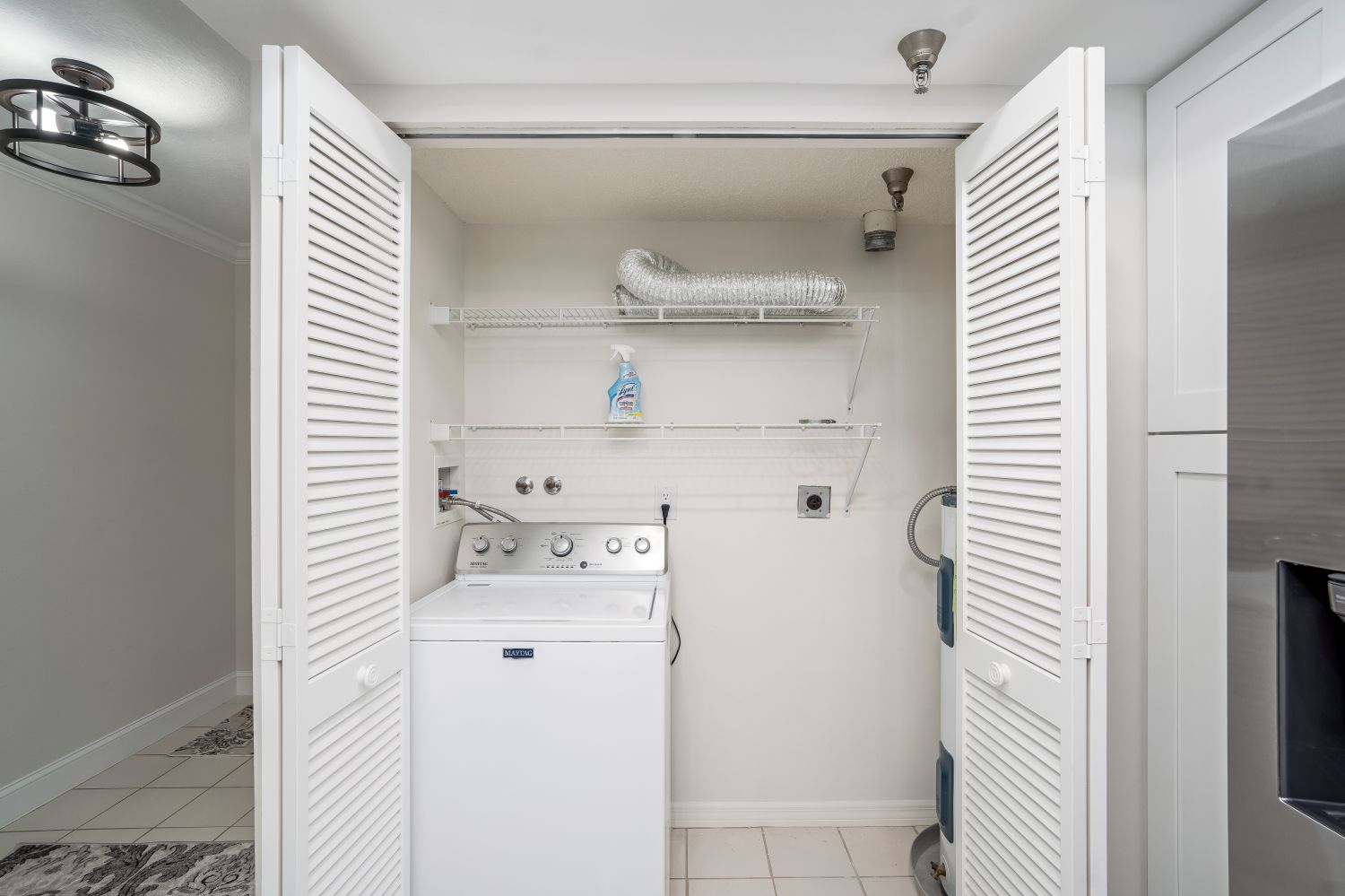 A laundry room with a washer and dryer in a closet.