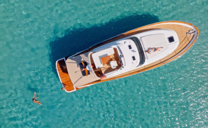An aerial view of a boat floating on top of a body of water.