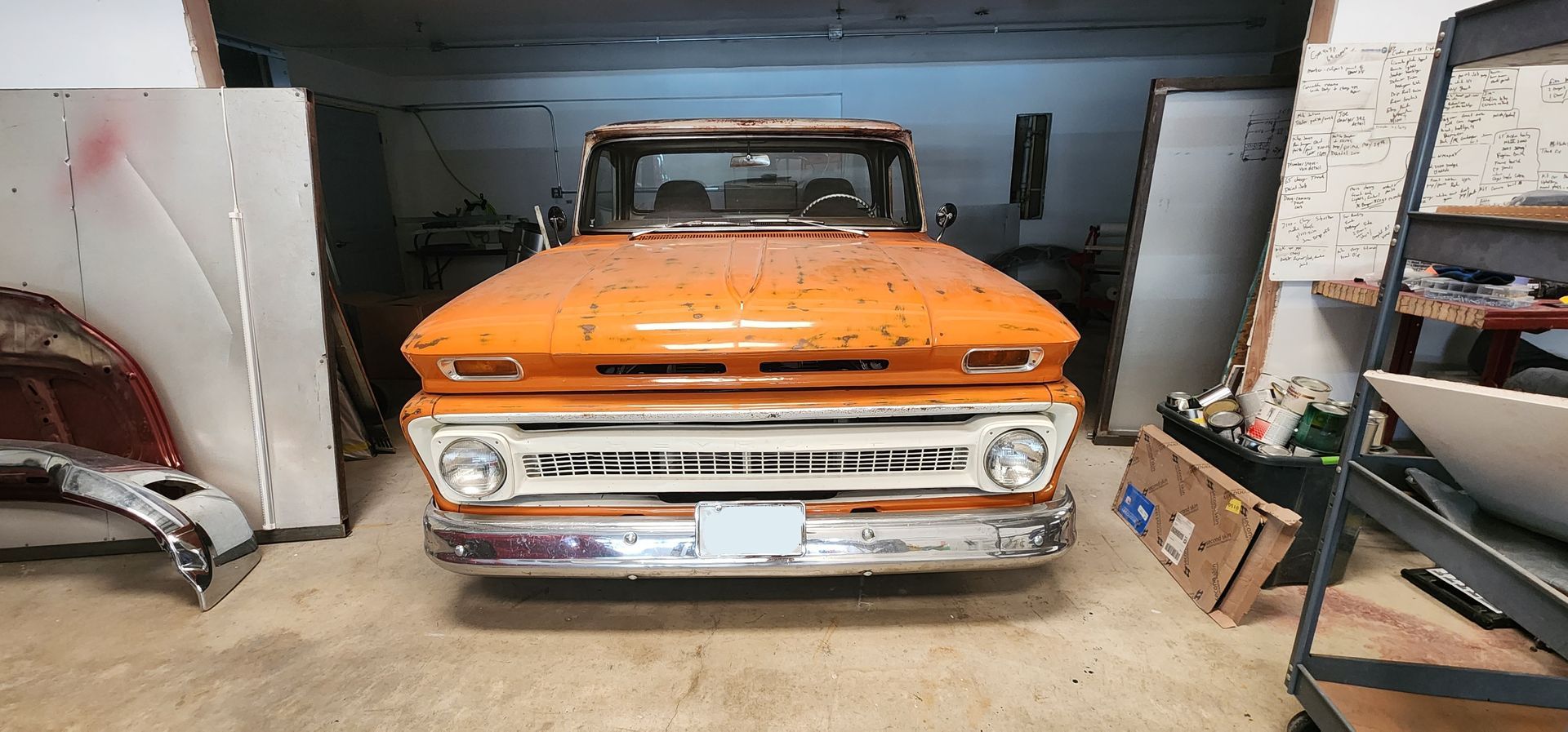 Light blue and white vintage pickup truck parked outside on a sunny day.