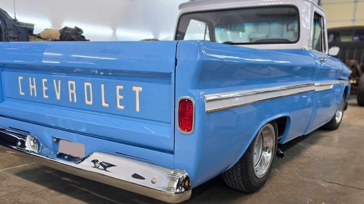 Blue and white classic Chevrolet pickup truck, rear view.