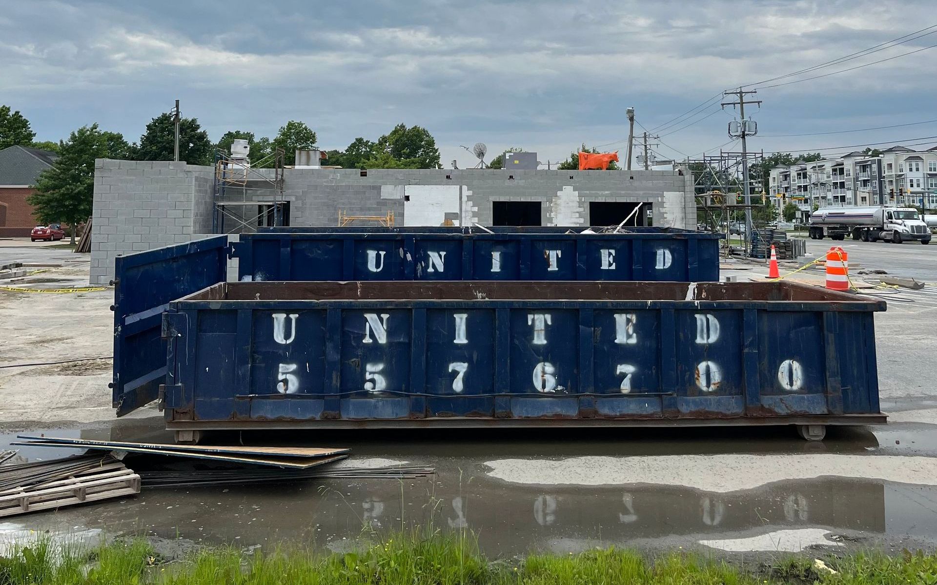 A blue dumpster with the word united on it A blue dumpster with the word united on it