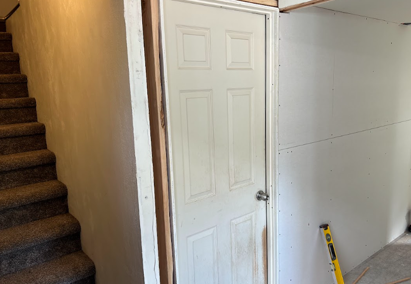 A man and a woman are working on a kitchen.