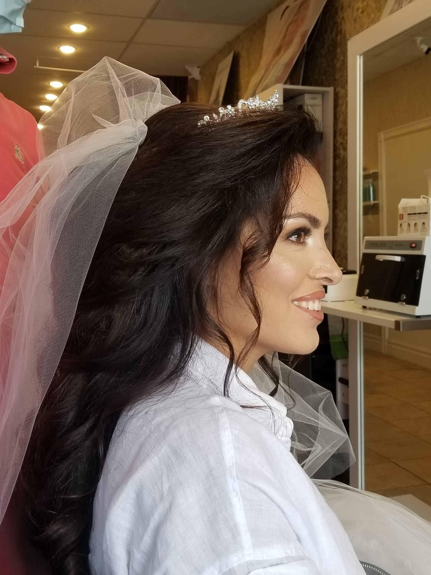 Photograph capturing the exquisite bridal makeup application by Celebrities Salon, complemented by a full package service including hairstyling, makeup, and other pampering treatments, epitomizing the salon's dedication to creating stunning looks for special occasions.