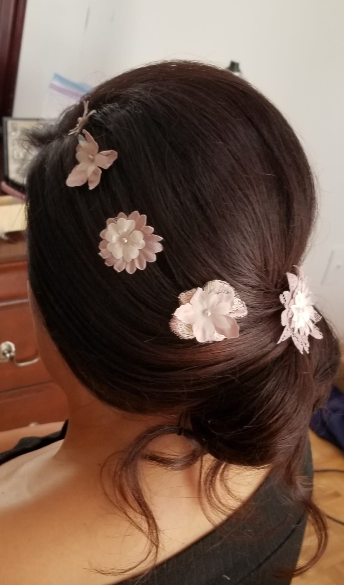 Image of a client with a stylish haute and bun hairstyle, demonstrating the intricate and elegant hairdressing skills offered by Celebrities Salon.