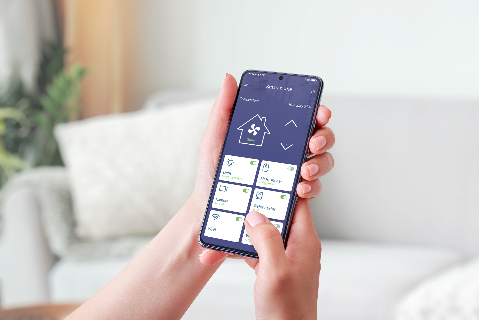 A person is holding a smart phone with an energy efficiency rating on the screen.
