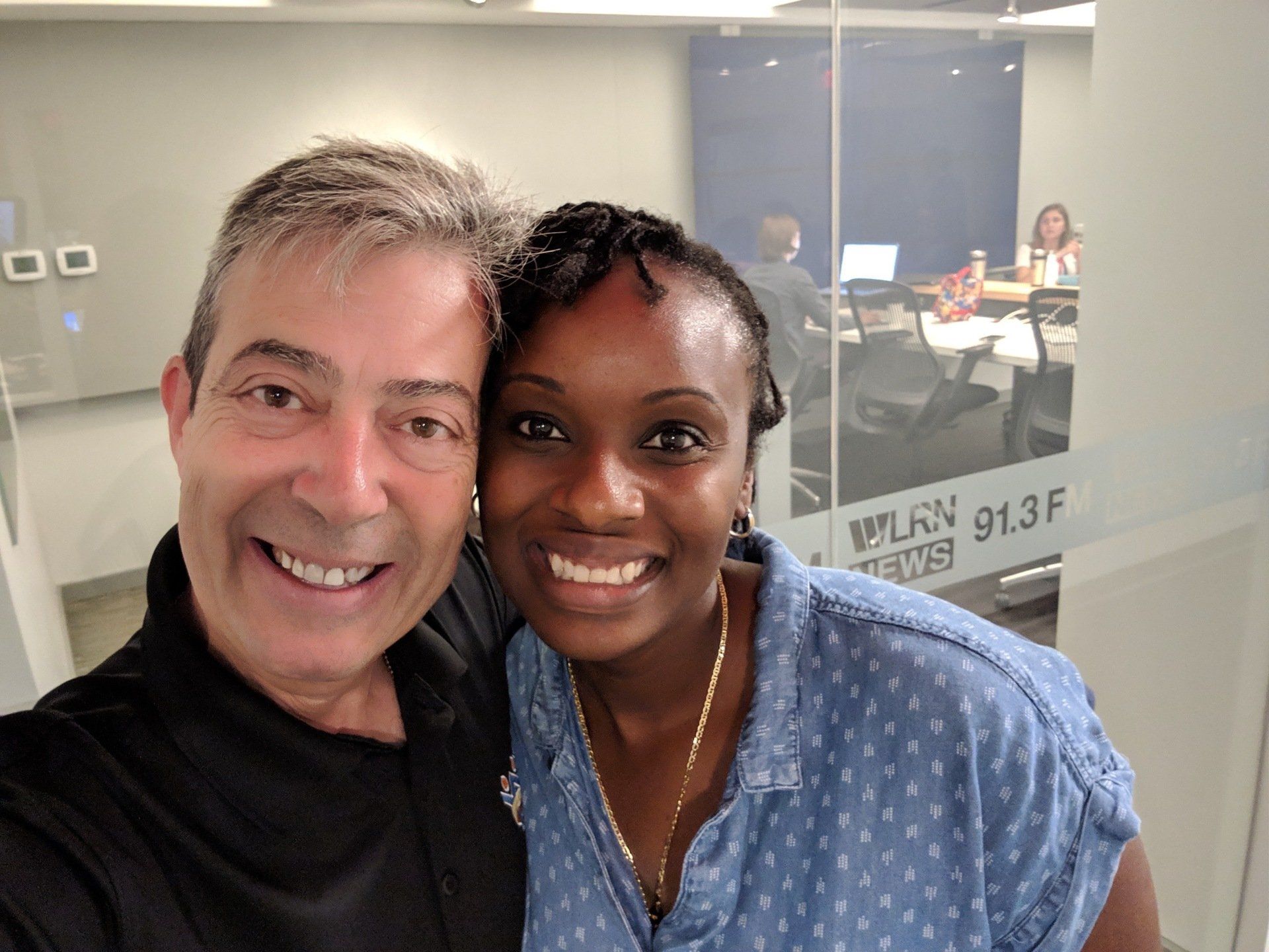 A man and a woman are posing for a picture in a room.