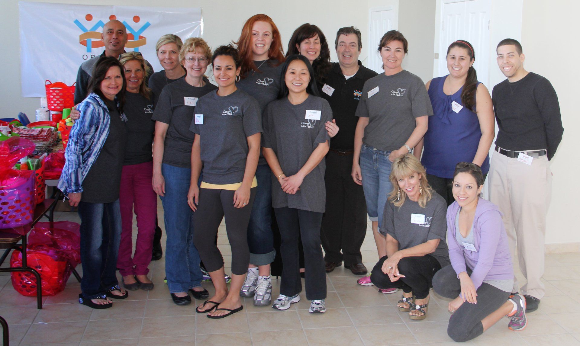 A group of people posing for a picture with one wearing a name tag