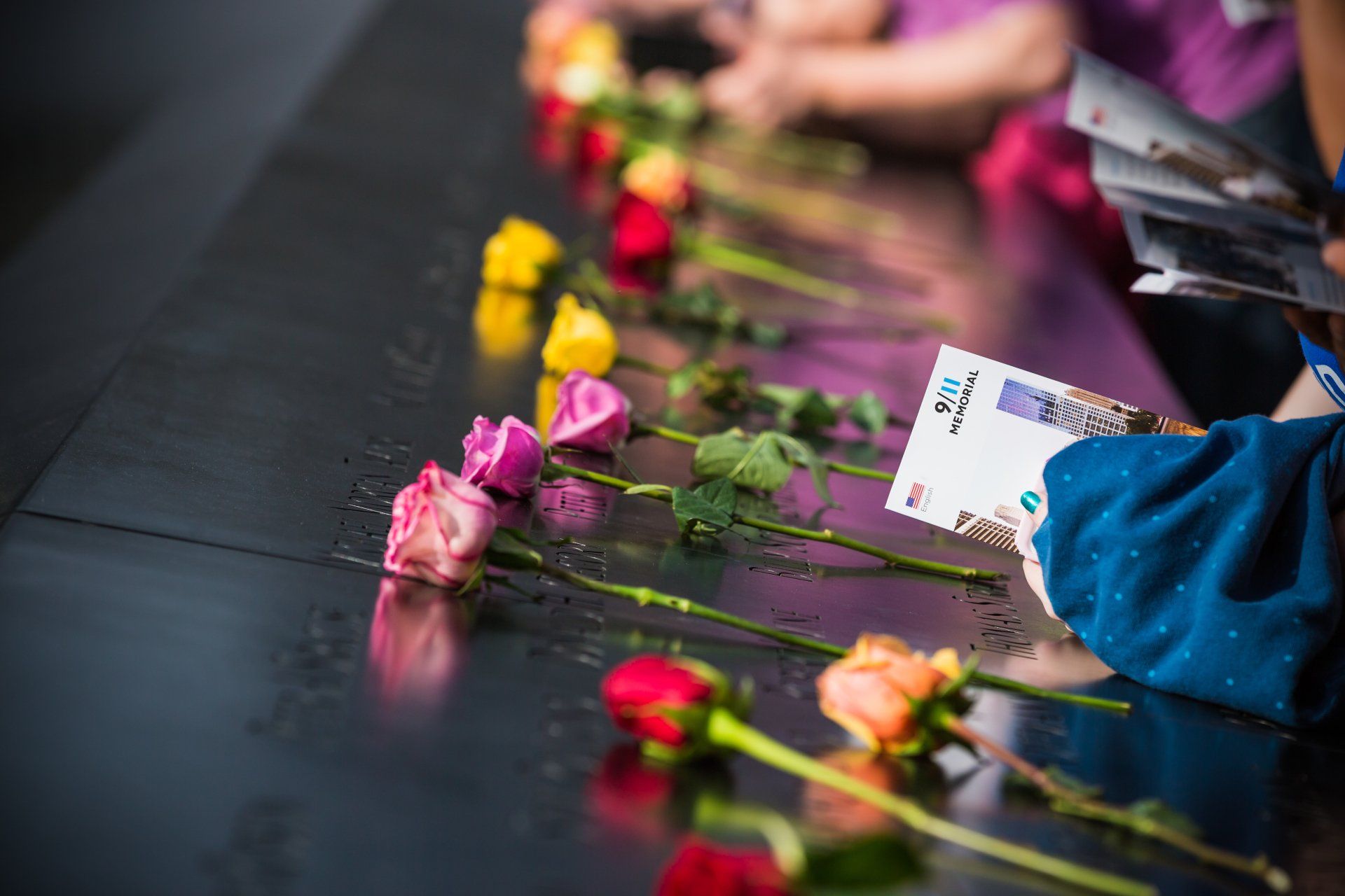 A group of people are sitting at a table with flowers and cards.