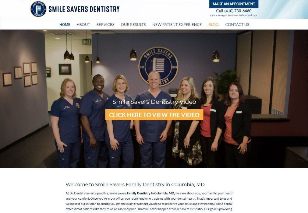 A group of people standing next to each other in a dental office.