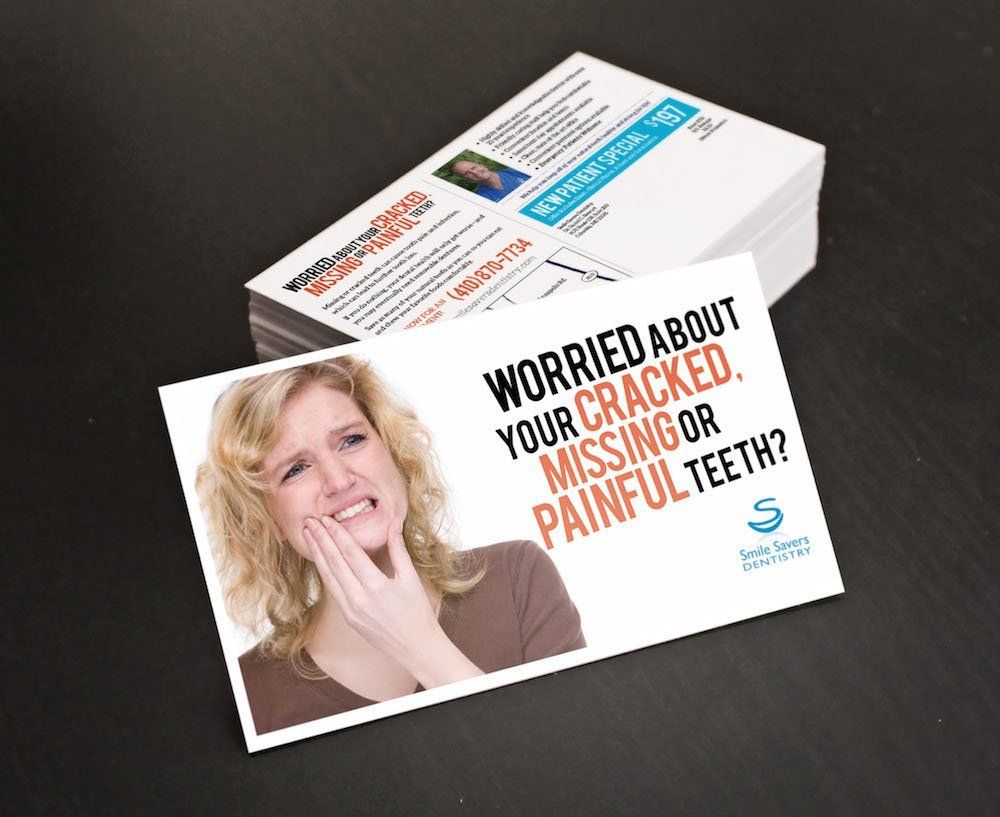A woman with a toothache is on a business card that says worried about your cracked missing or painful teeth