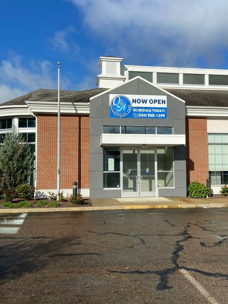 A building with a sign that says now open