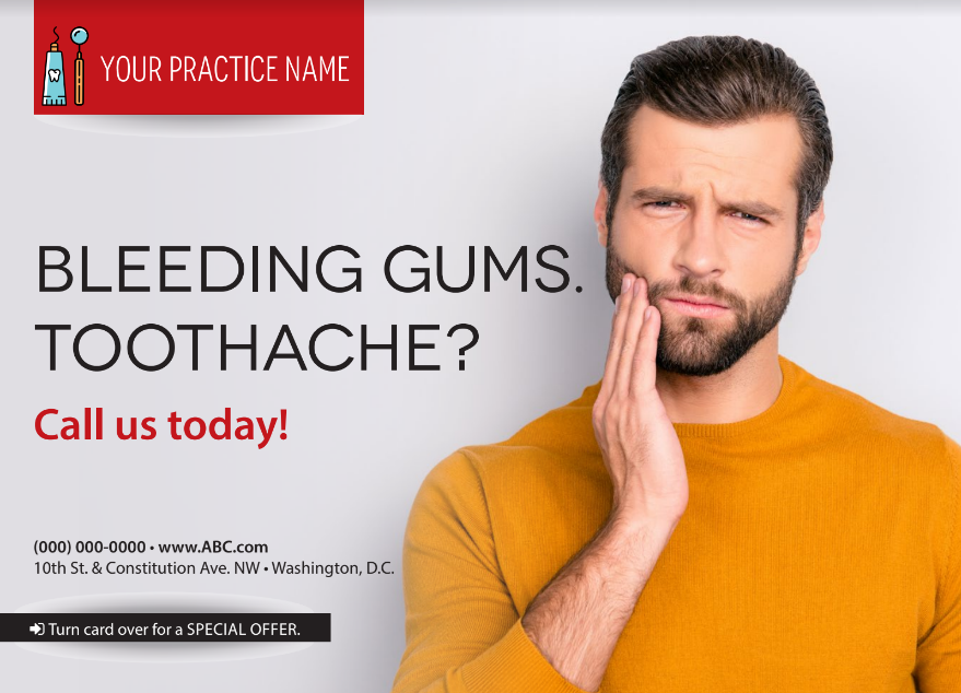 A man with a beard is holding his mouth in pain.