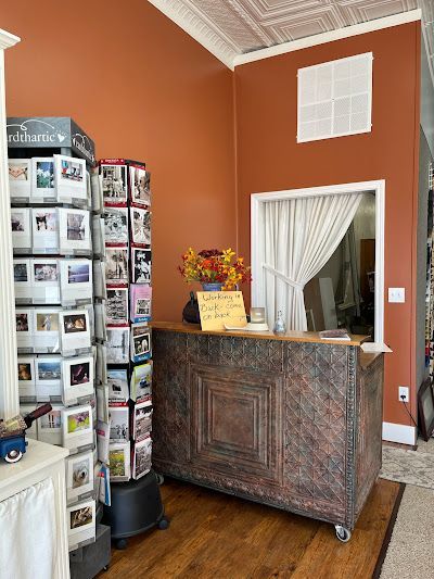 A room with a wooden counter and a display of greeting cards.