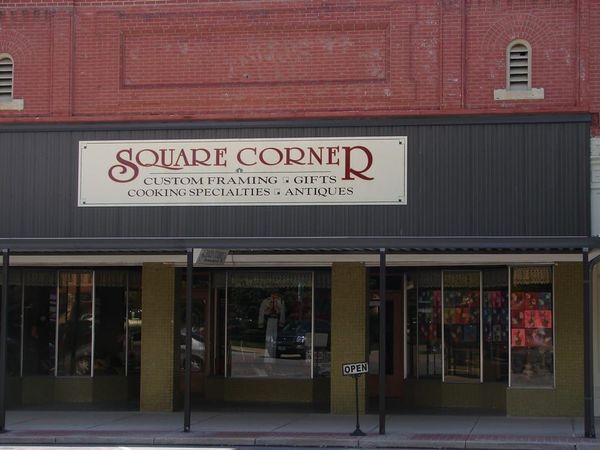 A store front with a sign that says square corner