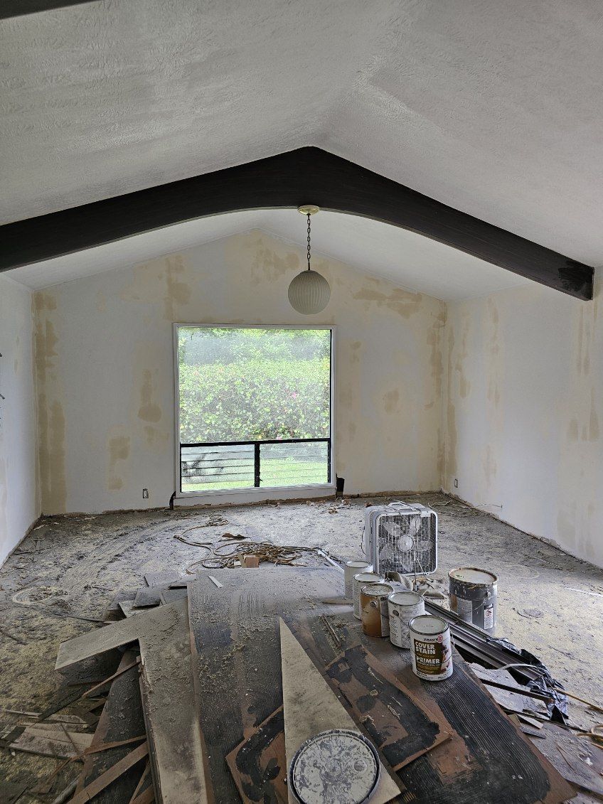 A room with a vaulted ceiling and a large window